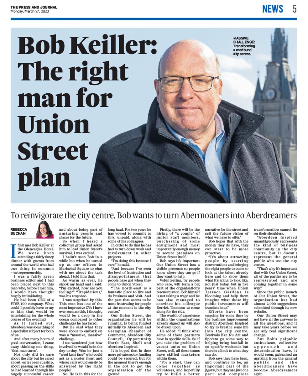 Press photographer aberdeen Scott Cameron Baxter, image shows a press cutting story of Bob Keiller, Aberdeen, looking into camera on a balcong overlooking the city of Aberdeen Scotland. Behind him is the town house, the sky is blue, he is wearing a blck coat and a blue business shirt. screenshot  showing photographs by Scott Cameron Baxter.