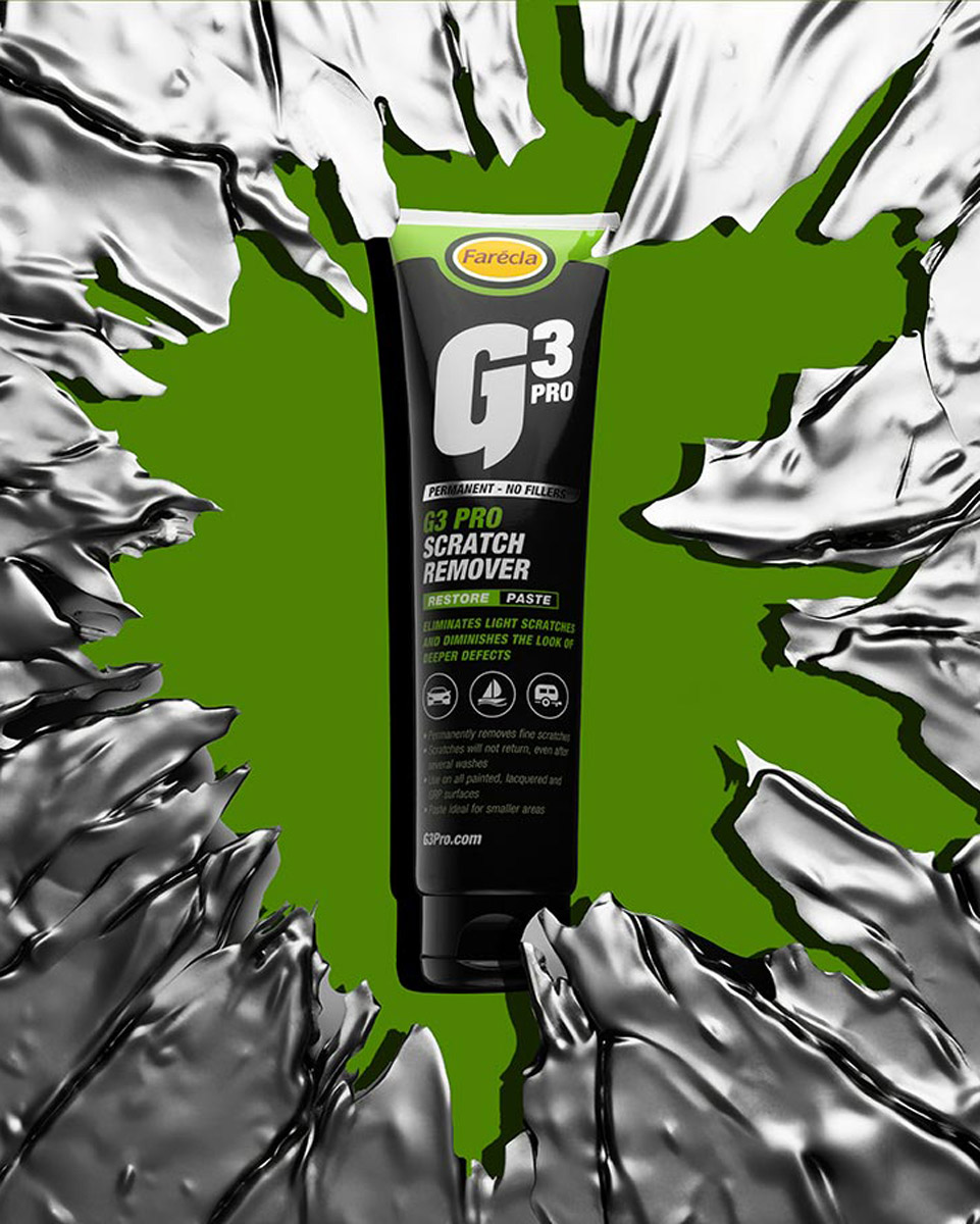 Commercial Product Photographer Aberdeen - Scott Cameron Baxter. Image shows a G3 Scratch remover black tube, it is photographed through metal which has been cut through the centre and the bottle is illuminated as if you were looking through the gap in the metal. The background through the metal is green where the black bottle is lit from each side. The metal is like aluminium and scratched and very jagged.